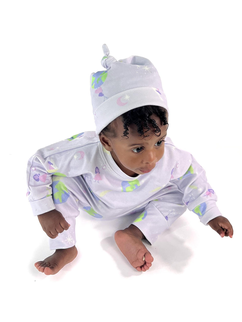 Soft organic lavender cotton baby set shown on a moving infant to demonstrate the flexible harem-style pants and non-bunching fit. She is wearing the matching knotted beanie. 